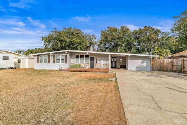 ranch-style house with a carport and a front lawn