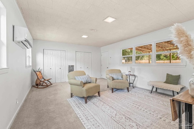 living area with an AC wall unit and light carpet