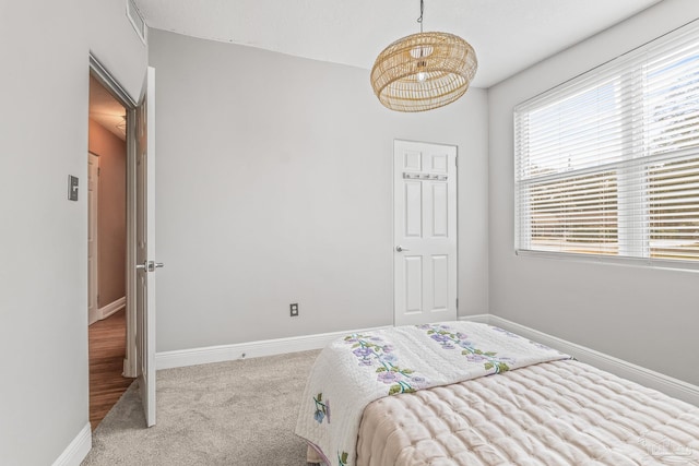 bedroom featuring light carpet