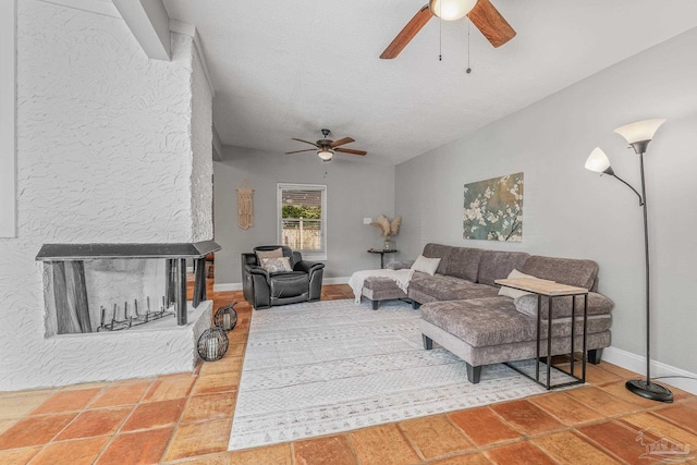 living room featuring ceiling fan, a multi sided fireplace, and lofted ceiling