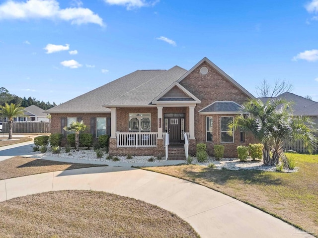 view of front of property with a porch and a front yard