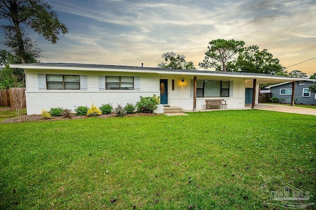 ranch-style house with a yard and a carport