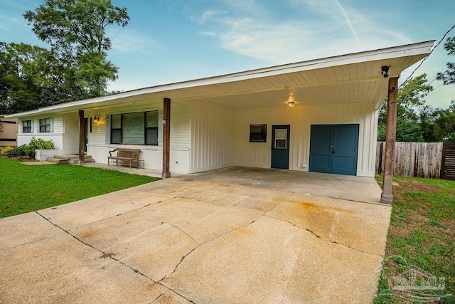 single story home featuring a carport and a front yard