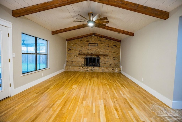 unfurnished living room featuring wooden ceiling, a fireplace, ceiling fan, lofted ceiling with beams, and light wood-type flooring