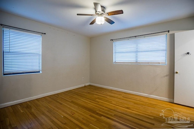 spare room featuring hardwood / wood-style flooring and ceiling fan