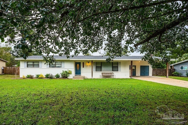 ranch-style home with a garage and a front yard