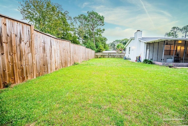 view of yard featuring a sunroom