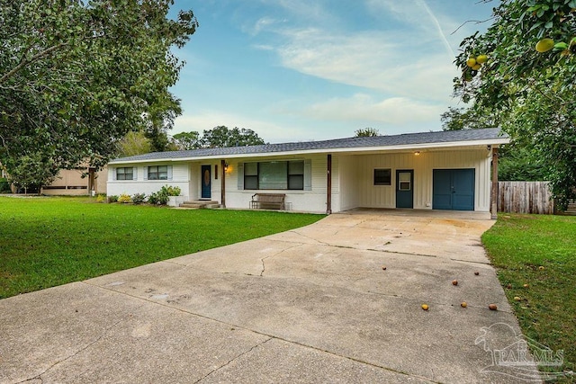 ranch-style home featuring a carport and a front yard