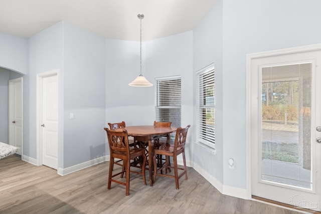 6743 Desoto St, Navarre, FL 32566 - dining space featuring light wood finished floors, arched walkways, and baseboards