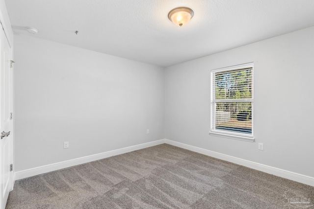 6743 Desoto St, Navarre, FL 32566 - carpeted empty room with baseboards and a smoke detector