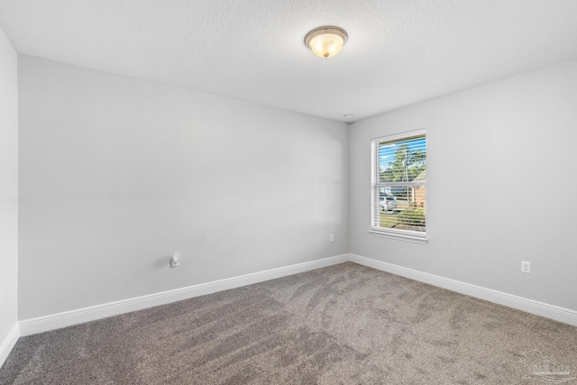 6743 Desoto St, Navarre, FL 32566 - spare room featuring carpet, baseboards, and a textured ceiling