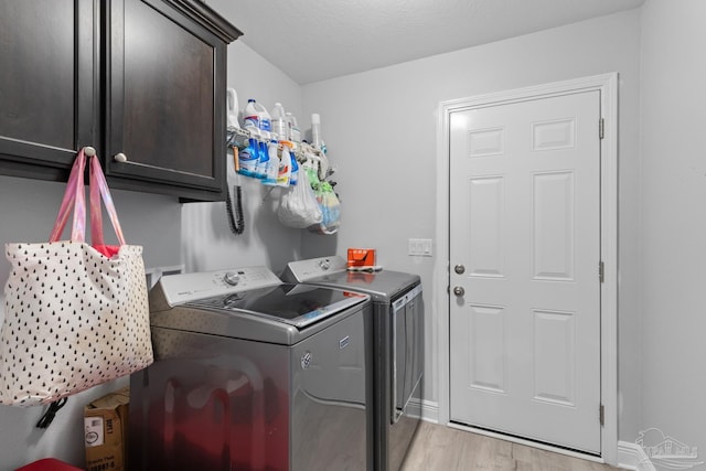 6743 Desoto St, Navarre, FL 32566 - laundry area with independent washer and dryer, cabinet space, light wood-style flooring, and baseboards