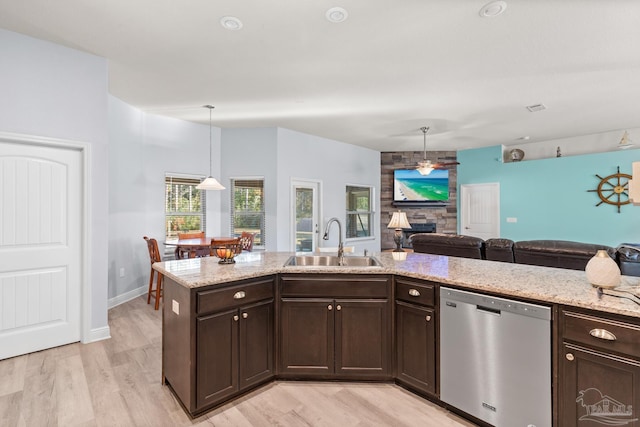 6743 Desoto St, Navarre, FL 32566 - kitchen with dishwasher, a sink, dark brown cabinetry, open floor plan, and light stone counters