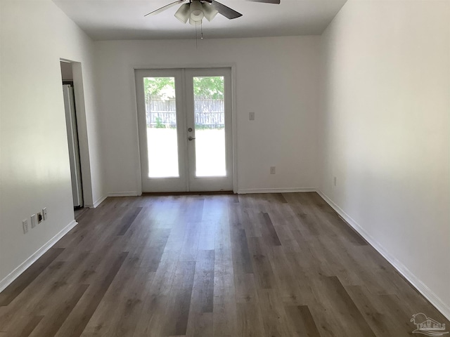 interior space featuring dark wood-style flooring, baseboards, a ceiling fan, and french doors