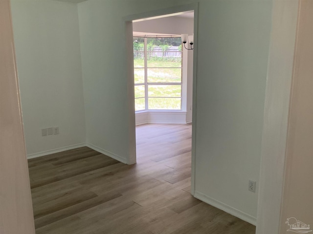 spare room with wood finished floors and baseboards