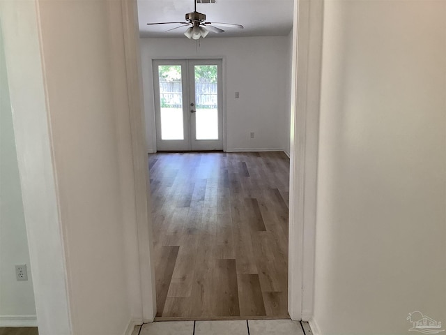 hall featuring baseboards, french doors, visible vents, and wood finished floors