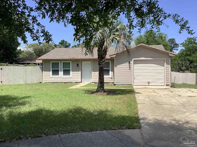 view of front of property with roof with shingles, fence, an attached garage, concrete driveway, and a front yard