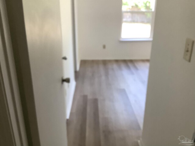 hall with wood finished floors