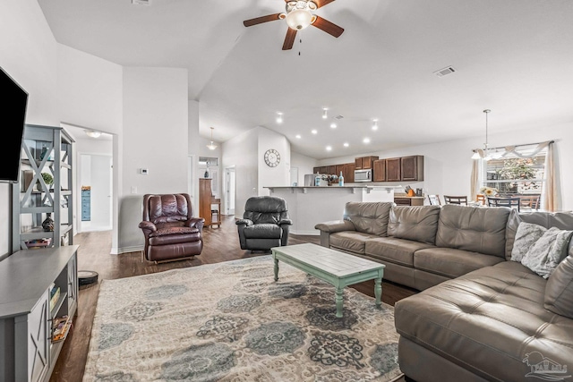 living room featuring high vaulted ceiling, ceiling fan, and dark wood-type flooring