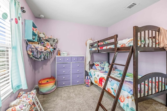 carpeted bedroom with multiple windows