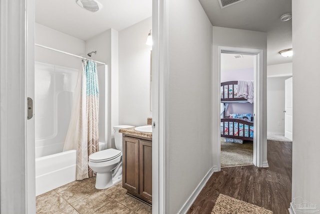 full bathroom featuring hardwood / wood-style floors, vanity, toilet, and shower / bathtub combination with curtain