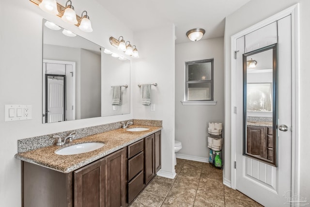 bathroom with tile patterned flooring, vanity, and toilet