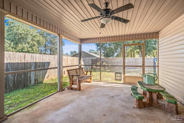 sunroom / solarium featuring ceiling fan and wood ceiling