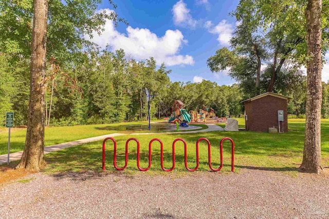 view of property's community with a playground and a yard