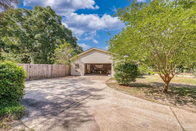 view of front of property featuring fence, driveway, and a carport