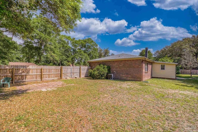 view of yard featuring a fenced backyard and central air condition unit