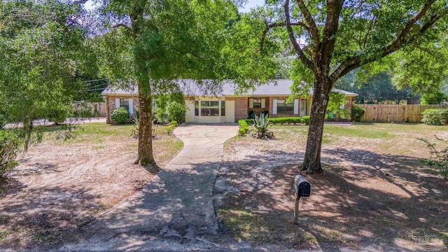 single story home featuring fence and driveway