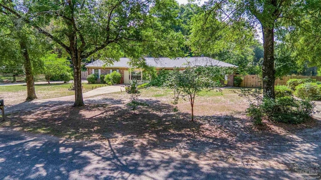 single story home featuring fence and driveway