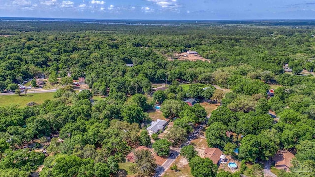 birds eye view of property featuring a wooded view