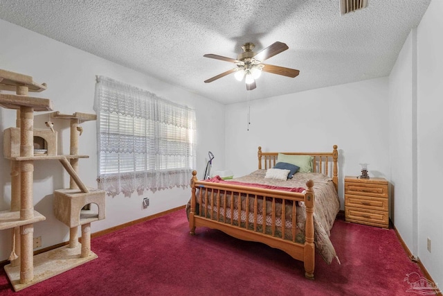 carpeted bedroom with baseboards, a ceiling fan, a textured ceiling, and visible vents