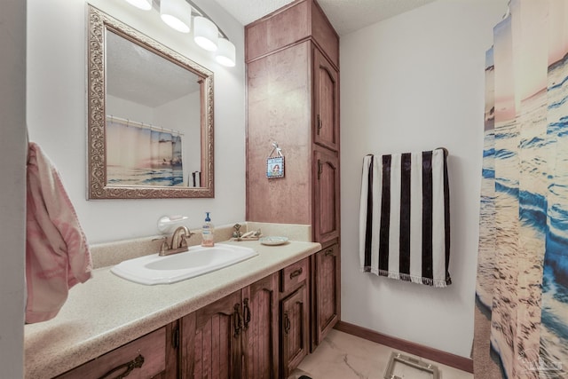 bathroom featuring vanity and marble finish floor