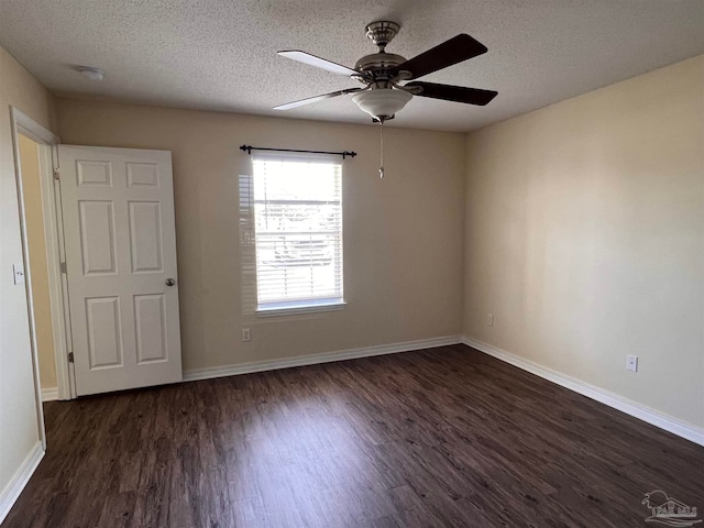 empty room featuring a textured ceiling, ceiling fan, and dark hardwood / wood-style flooring