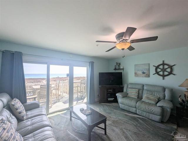 living area with ceiling fan and carpet