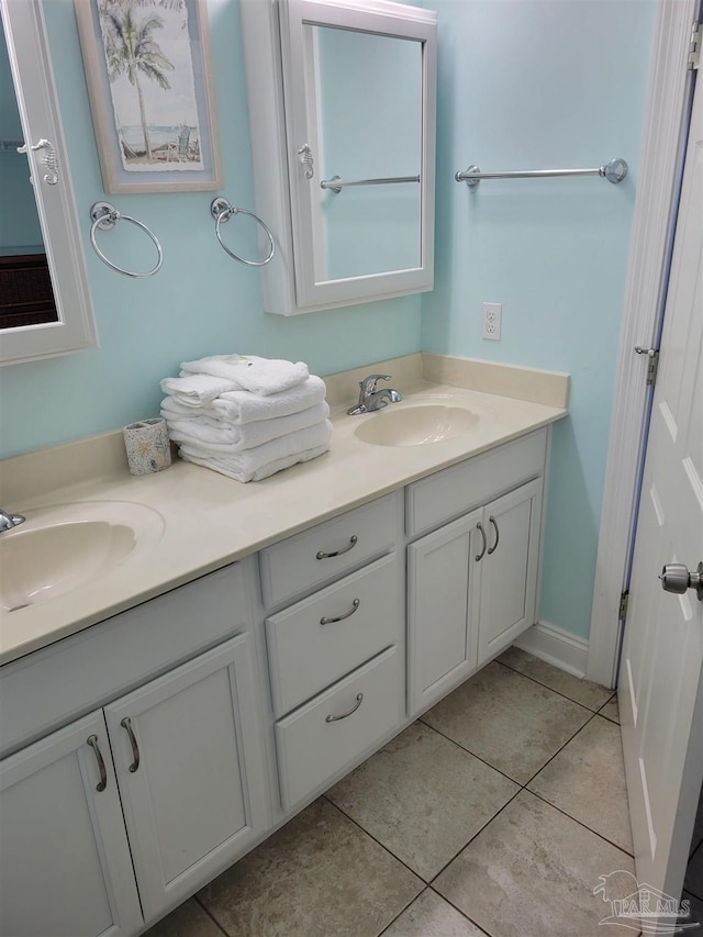 bathroom featuring double vanity, a sink, and tile patterned floors