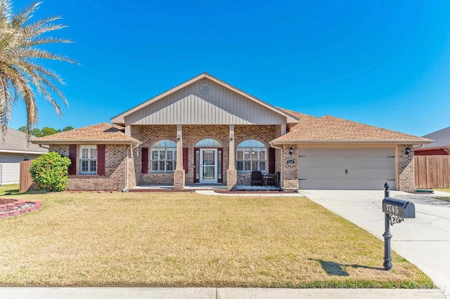 view of front of property featuring concrete driveway, brick siding, a front yard, and fence