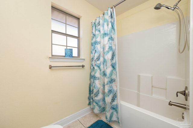 full bath featuring tile patterned flooring, shower / bathtub combination with curtain, and baseboards