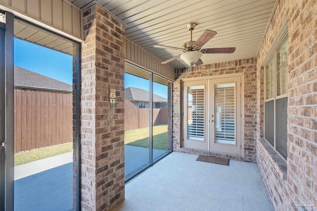 unfurnished sunroom with ceiling fan