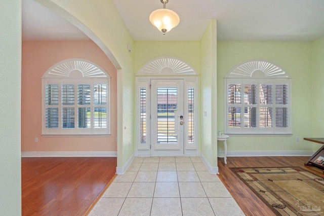 entryway featuring baseboards and wood finished floors