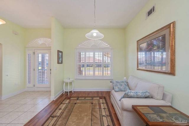 interior space with baseboards, visible vents, and wood finished floors