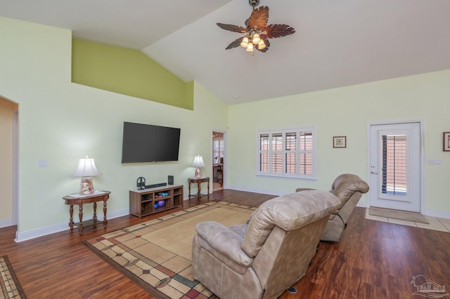 living room with ceiling fan, high vaulted ceiling, wood finished floors, and baseboards