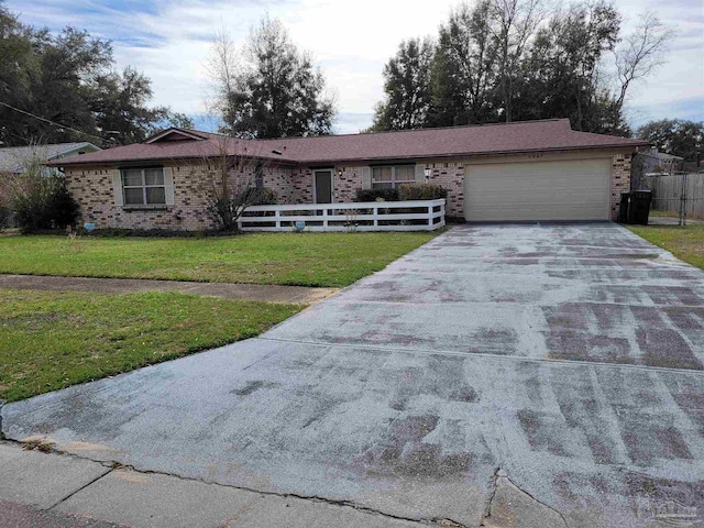 ranch-style house featuring a garage and a front yard