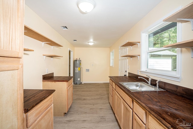 kitchen featuring light brown cabinets, sink, light hardwood / wood-style flooring, and electric water heater