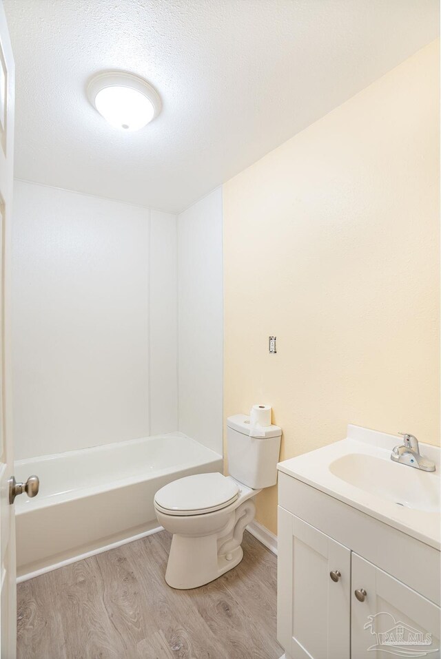 full bathroom with vanity, shower / bathtub combination, toilet, and hardwood / wood-style flooring