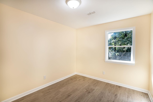 spare room with hardwood / wood-style flooring