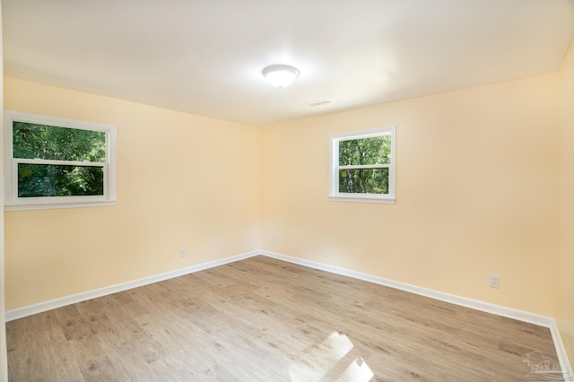 unfurnished room with light hardwood / wood-style flooring