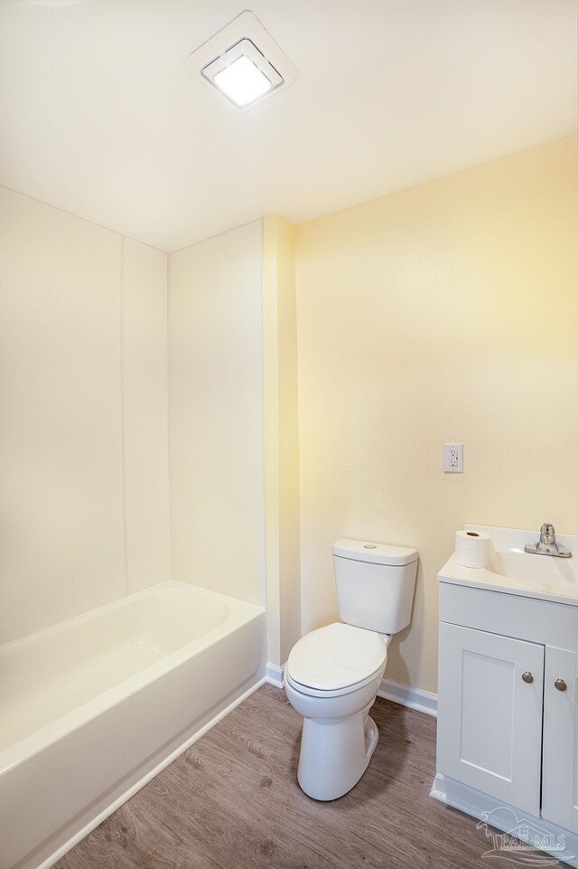 full bathroom featuring tub / shower combination, wood-type flooring, vanity, and toilet